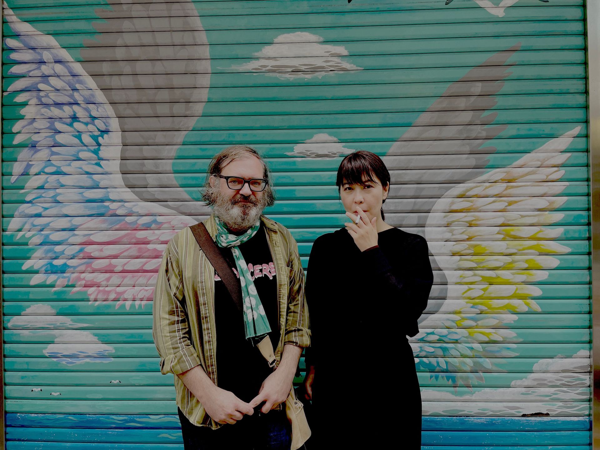 Jim O'Rourke & Eiko Ishibashi portrait in front of painted wall