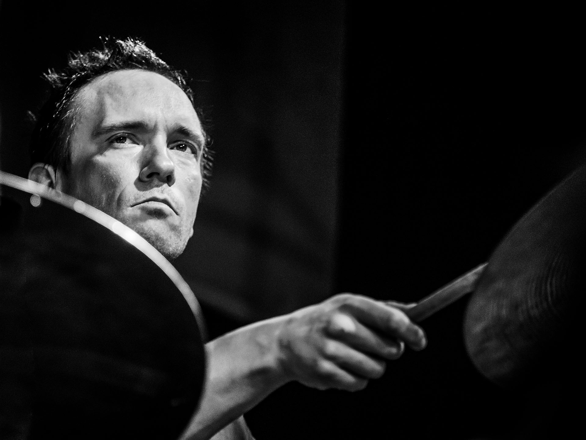 Paal Nilssen-Love playing drums black & white photo by Peter Gannushkin